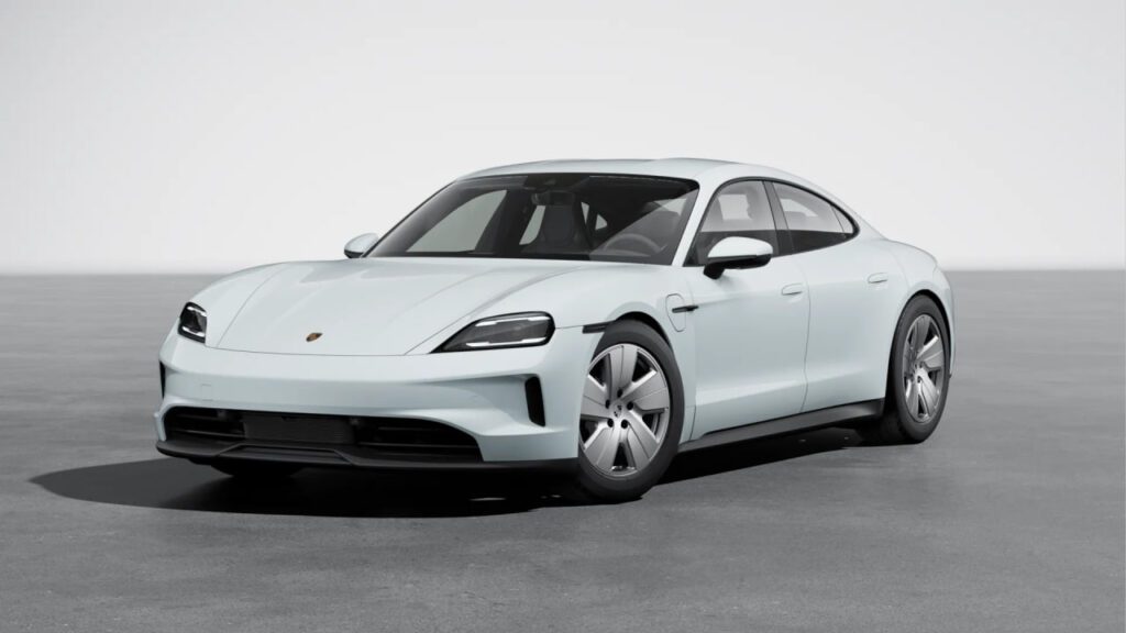 The Porsche Taycan electric sports sedan on the road, showcasing its sleek design and advanced features.